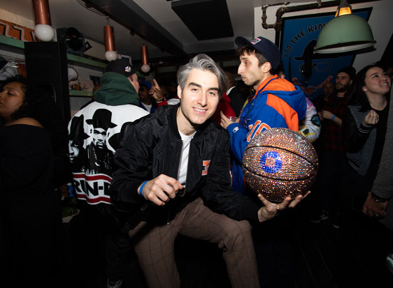 Knicks fan holds glittery basketball with a Chase logo