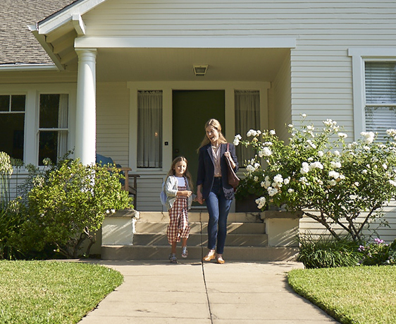 Mother and daughter walking out of the house