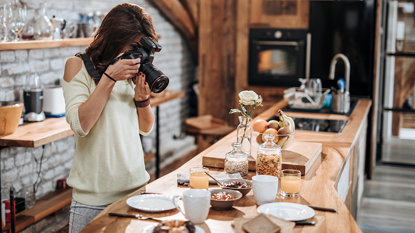 How To Manage Taxes When You Re A Freelancer - young female focuses her camera to take a photo your money