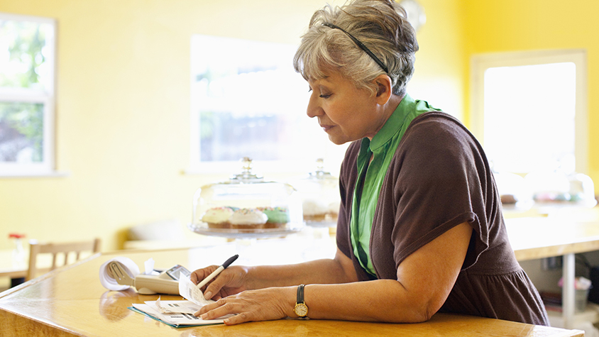 A woman reviews financial documents