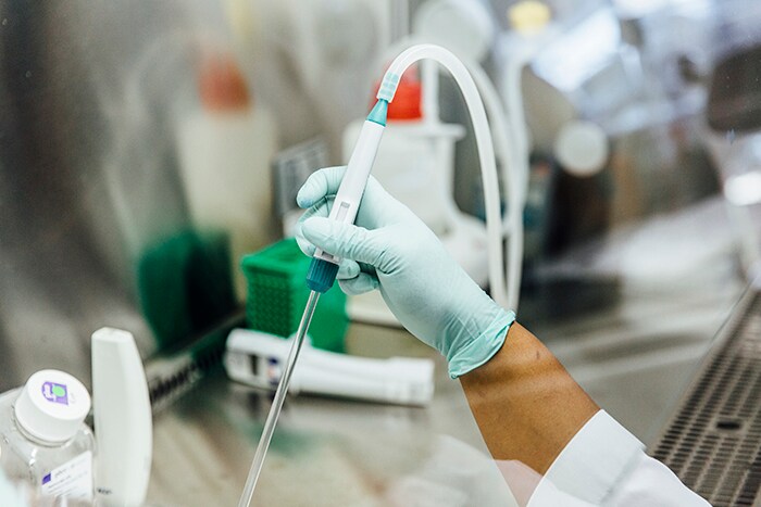 EpiBone profile person's hand holding a lab equipment