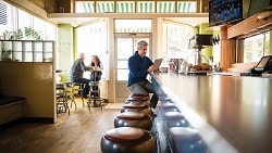 Spending and saving through the years man sitting at counter