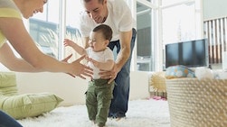 6 savings tips for new parents—from experienced parents young couple plying with infant