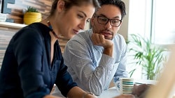 How to choose the right type of credit for your business man & woman looking at computer