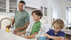 When and Why You Should Start Giving Your Child an Allowance dad in kitchen with children