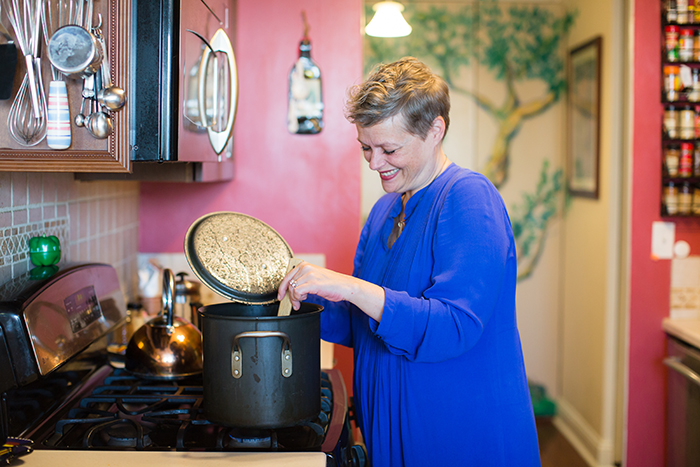 Savings Diaries: Kate Chapman middle age woman cooking in kitchen