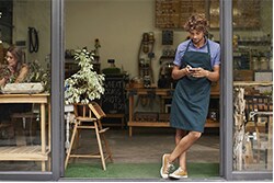 How small businesses should be using Yelp man standing outside his shop