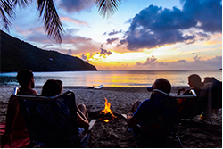 Call of the wild people at beach with camp fire