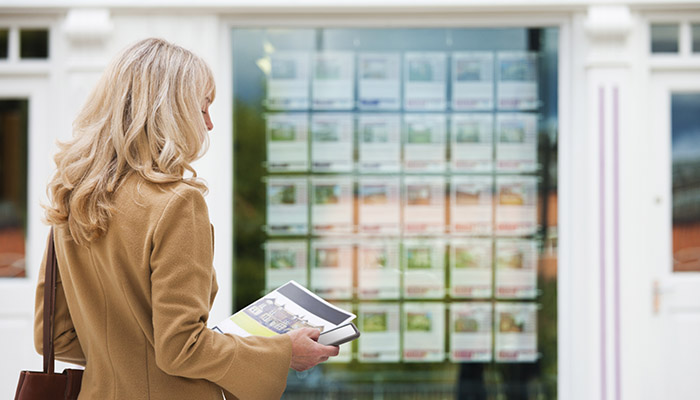 Women + Money Moments woman holding smartphone and paper
