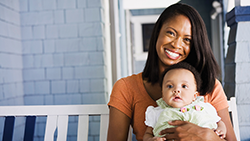 A guide to setting up the nursery without breaking the bank mom holding infant baby