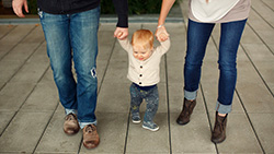 New Parents, New Purchases: Getting Your Credit in Check parents walking infant kid