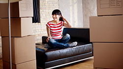 Your First Apartment, a Survival Guide Woman sitting on sofa