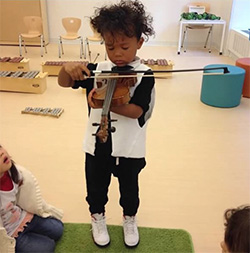 Have family jam sessions Kid playing violin