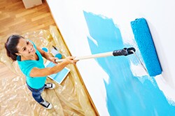 Wall Makeovers Woman painting wall