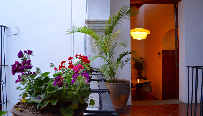 Oaxaca's Top Chef Rodolfo Castellanos Inside view of hotel where flower baskets are hanging on railing