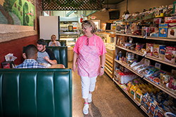 How The Music Festival Explosion Fuels Small Business Woman walking in a café