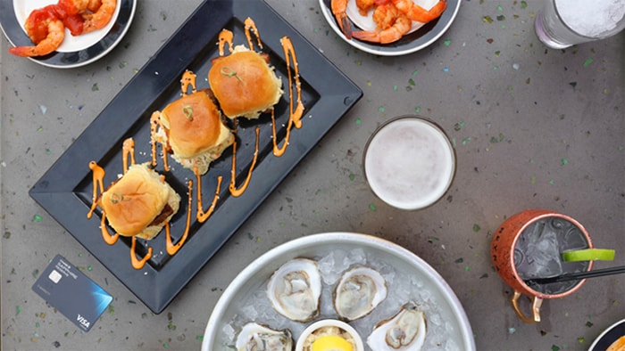 Charlotte Travel Guide food and drinks on a table besides Chase Sapphire Reserve card