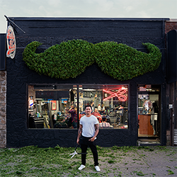 Cutting Edge Rich Mendoza in front of his shop