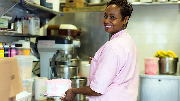 061418-recipe-for-success-sec-2 Aliyyah Baylor standing behind her dessert case