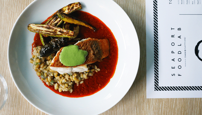 In the kitchen with: Alon Shaya food plate on table with flyer