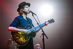 The Lumineers man playing electric guitar