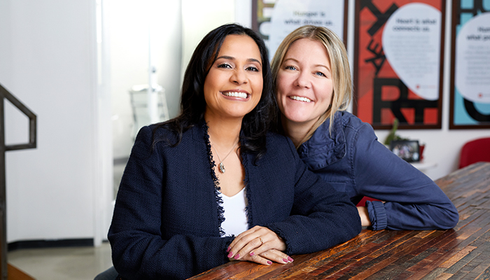 This CEO dreams big, innovates quickly—and succeeds Couple sit together at a table.