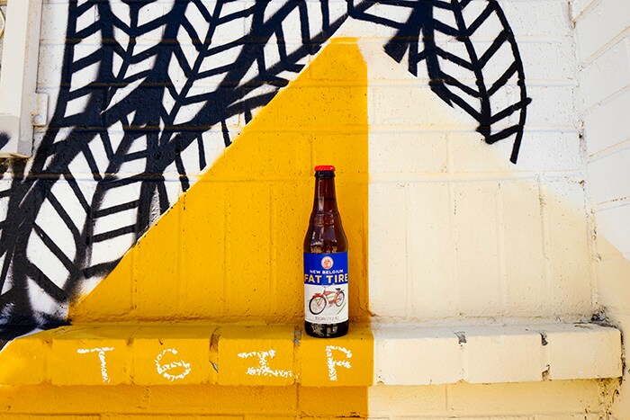 Entrepreneur empowers employees to brew an innovative culture image #1 Beer bottle in front of mural