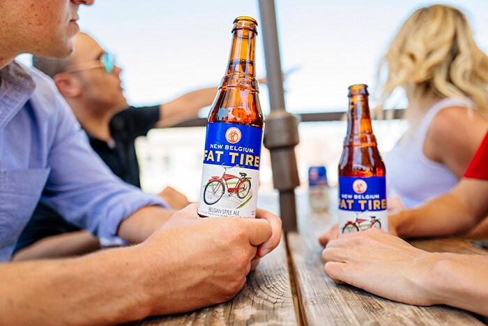 Entrepreneur empowers employees to brew an innovative culture image #4 Customers holding opened beer bottles