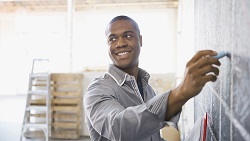 Tools to manage your business cash flow man writing on a chalkboard