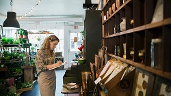 5 habits that keep business spending in control woman writing in a notepad