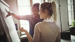 How to build and motivate your team image #2 Man and woman discussing strategy