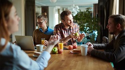 How to build and motivate your team People discussing strategy while having breakfast