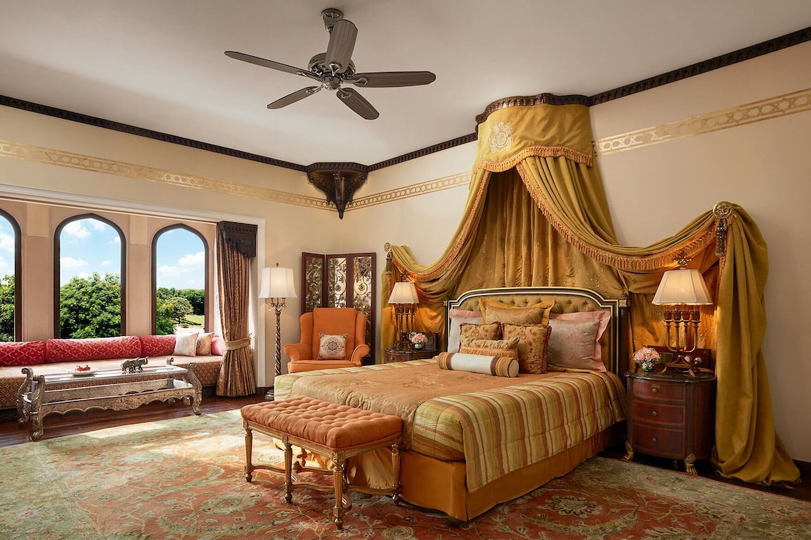 Hotel room with large bed, seating area, and ceiling fan.