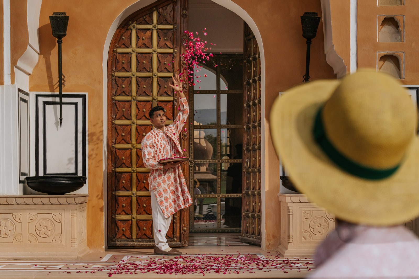 A man welcomes visitors to the Oberoi Rajvilas in Jaipur, India.
