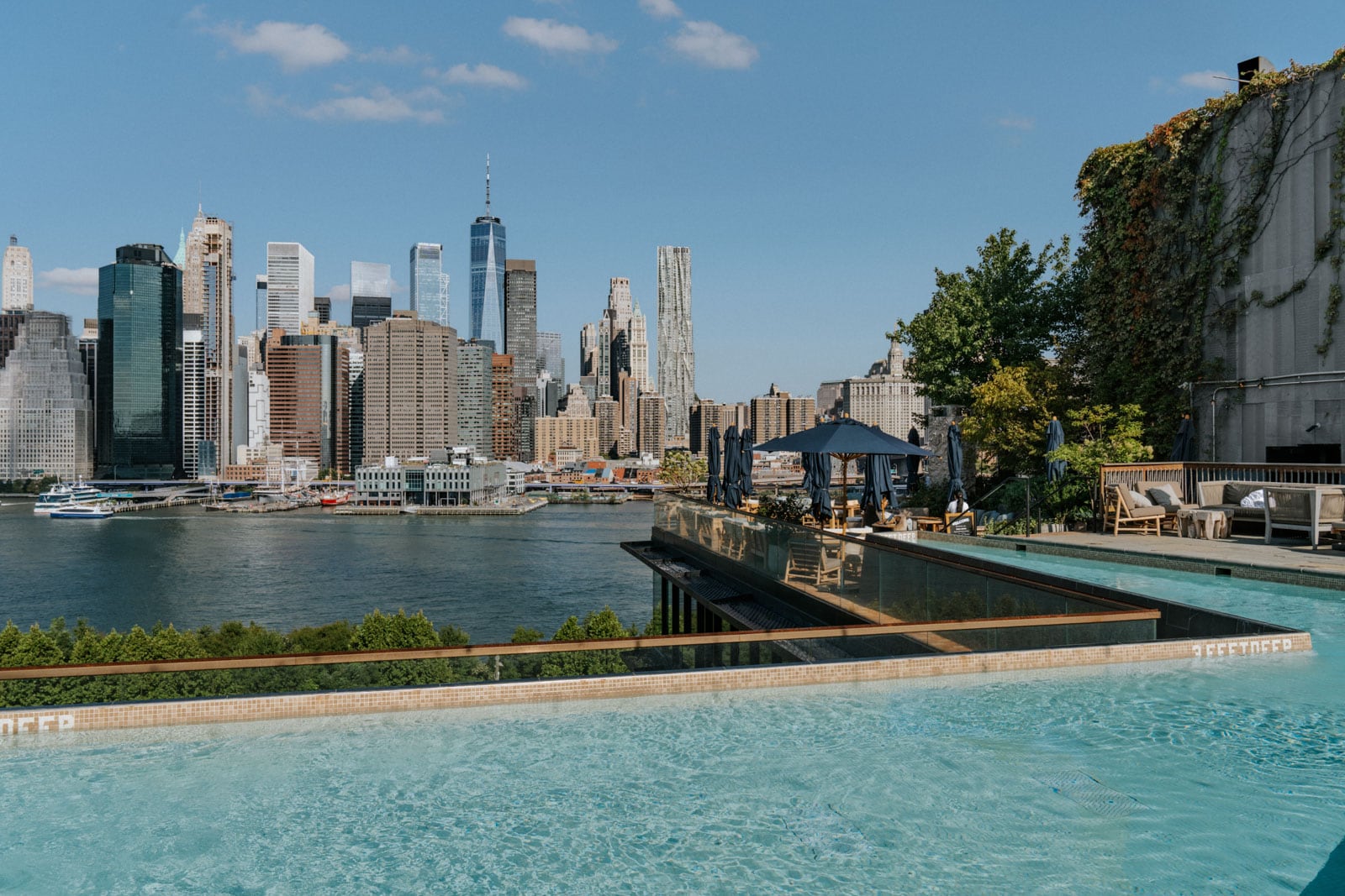 A pool overlooks the East River Estuary and Financial District in New York City.