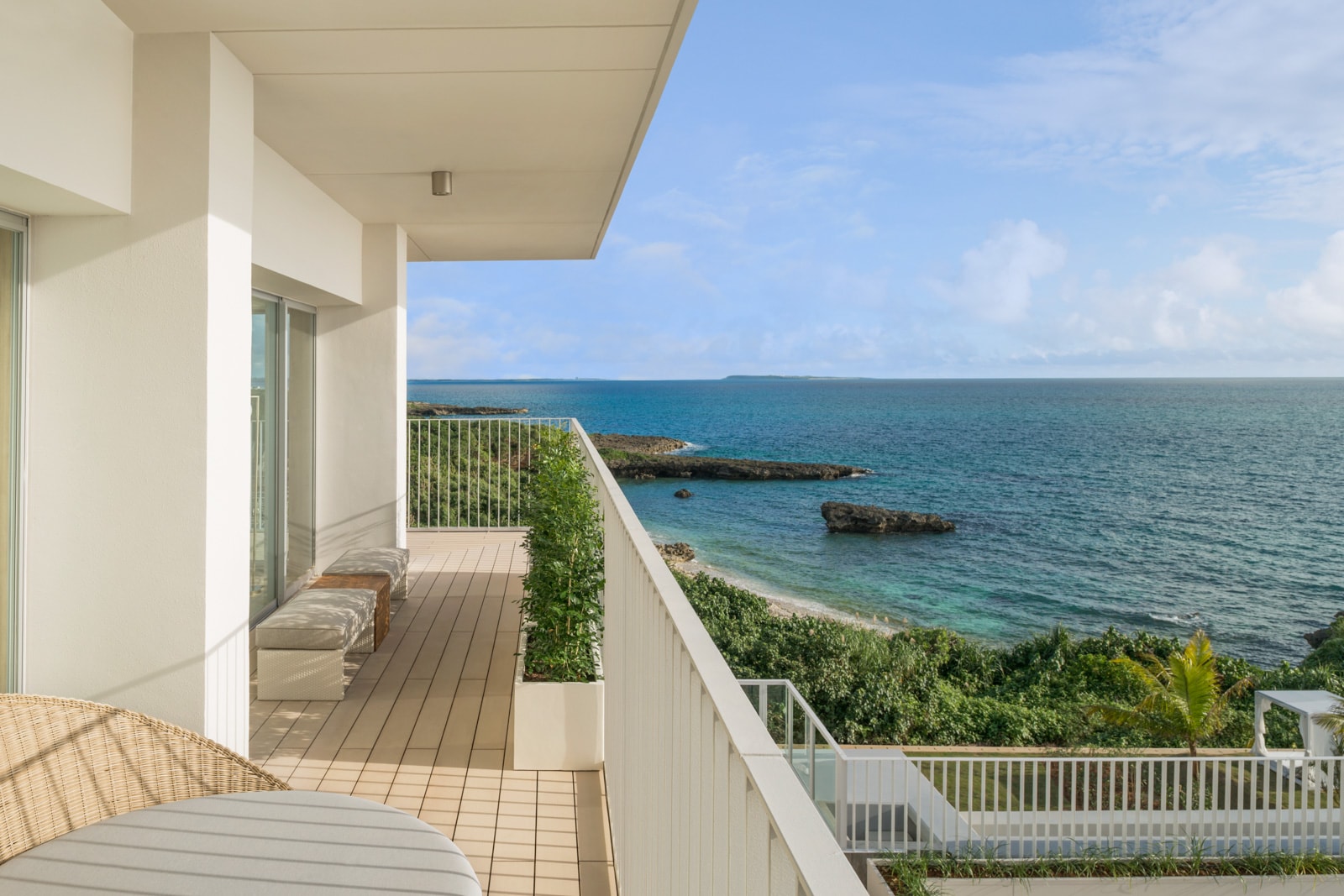A view from a hotel suite balcony of the ocean.