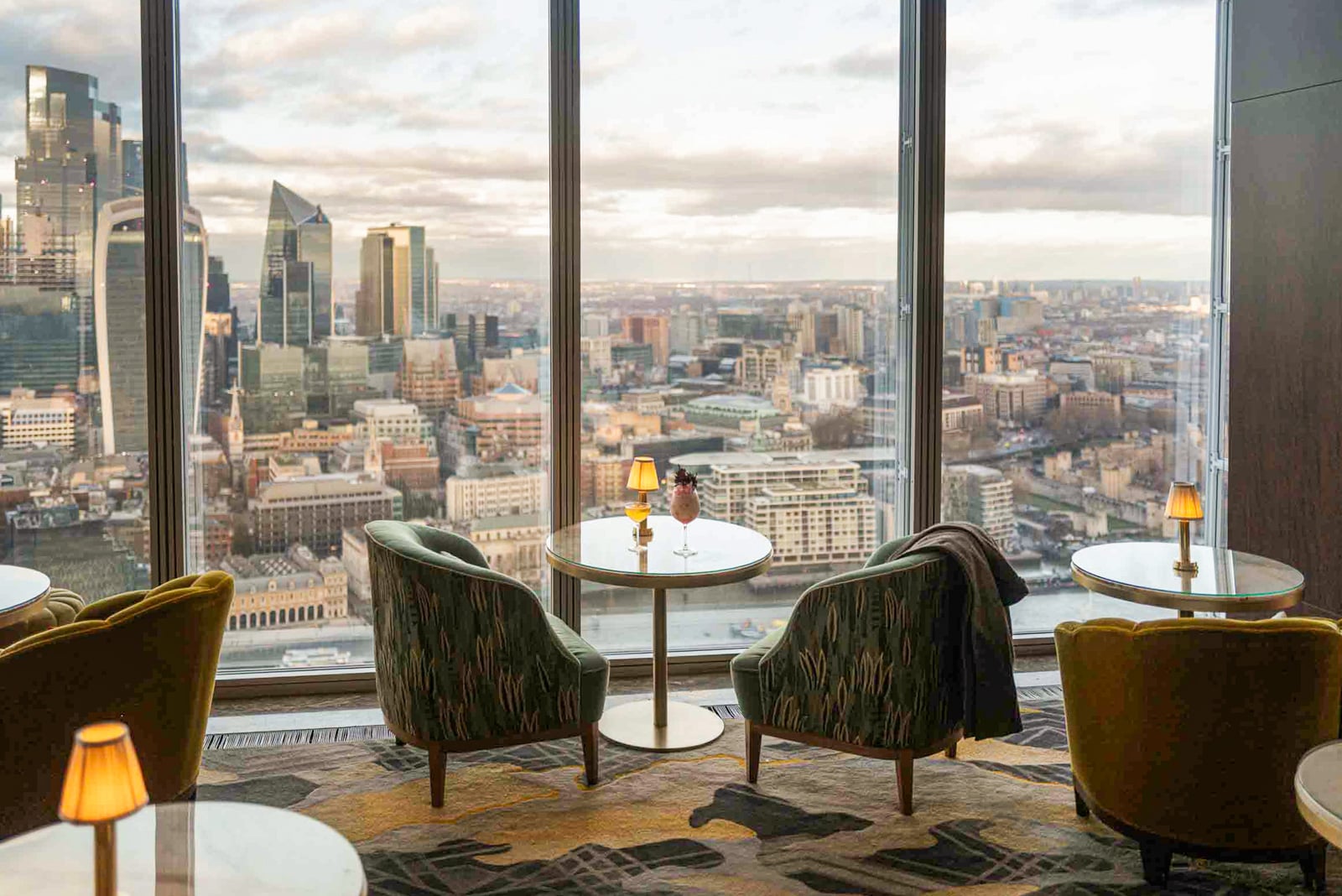 Two lounge chairs face a window looking out toward London from Shangri-La The Shard hotel.