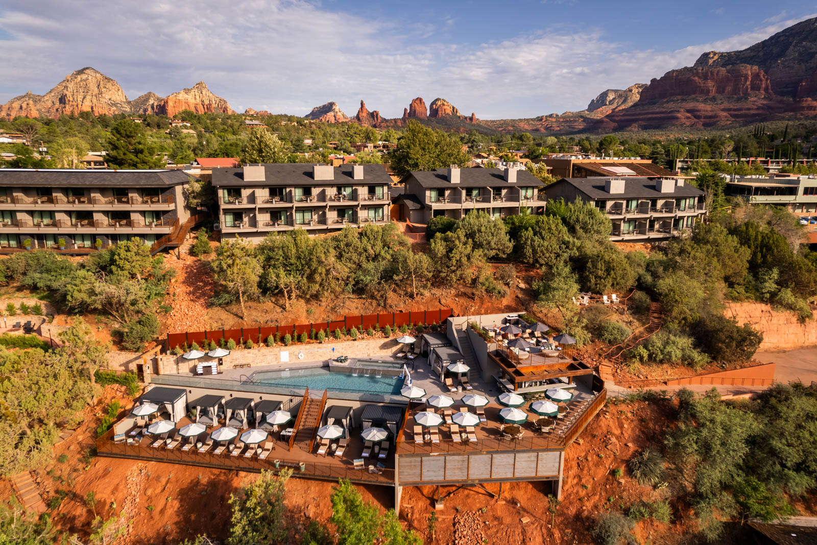 Aerial view of a hotel with rock formations in the background.