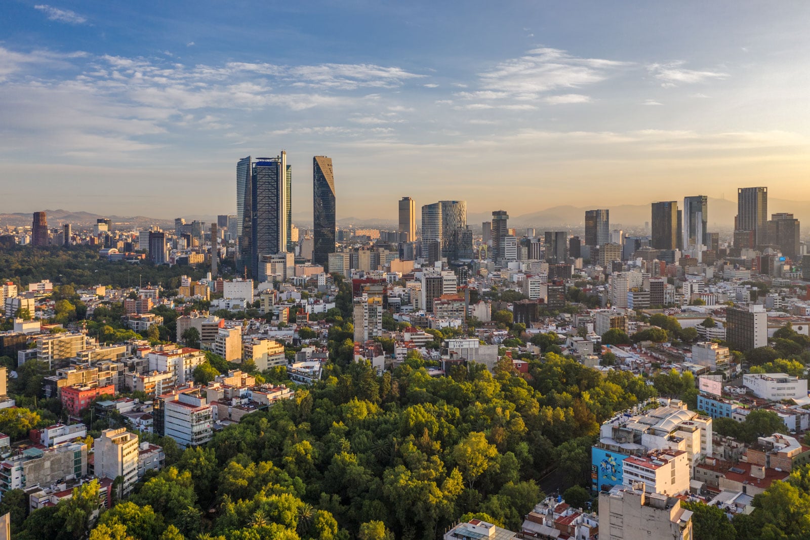 Aerial panoramic view of the skyline of Mexico City during sunrise.