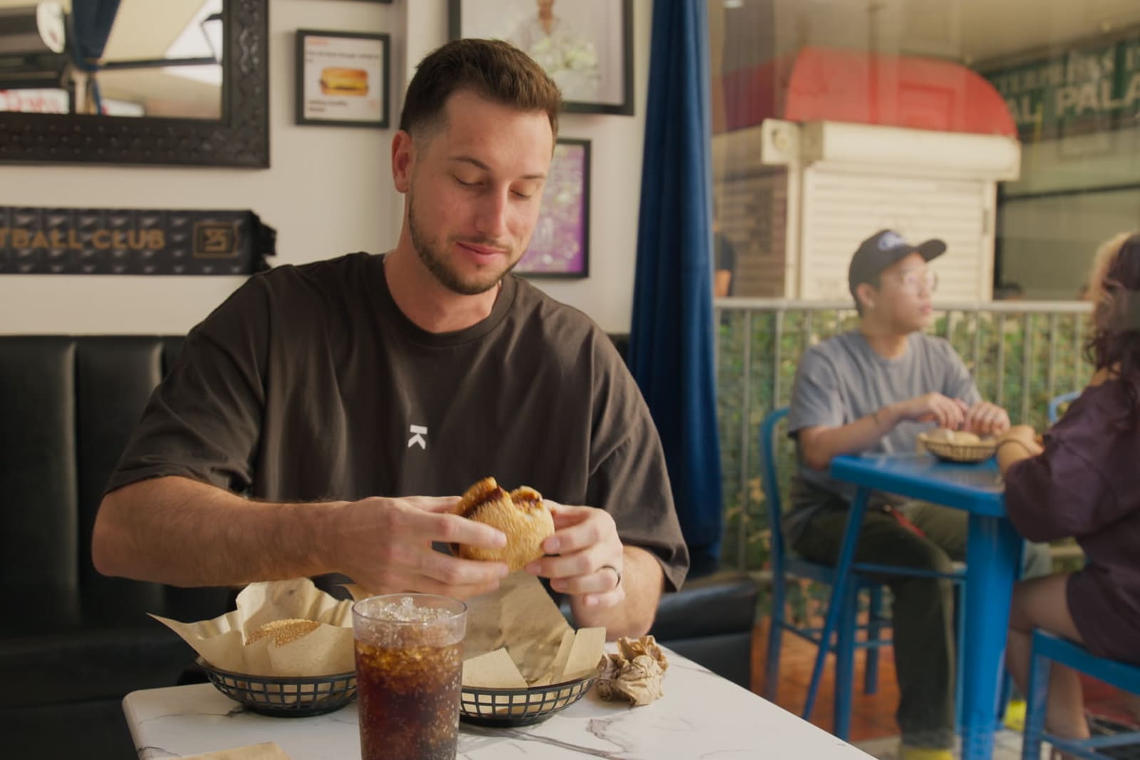 Kyle Tucker eats a burger at Amboy, a restaurant in Los Angeles.