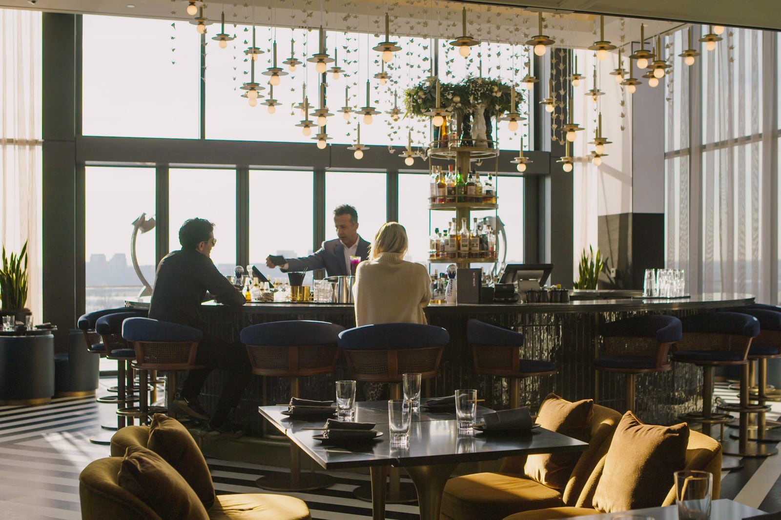 Two customers are served at a bar.