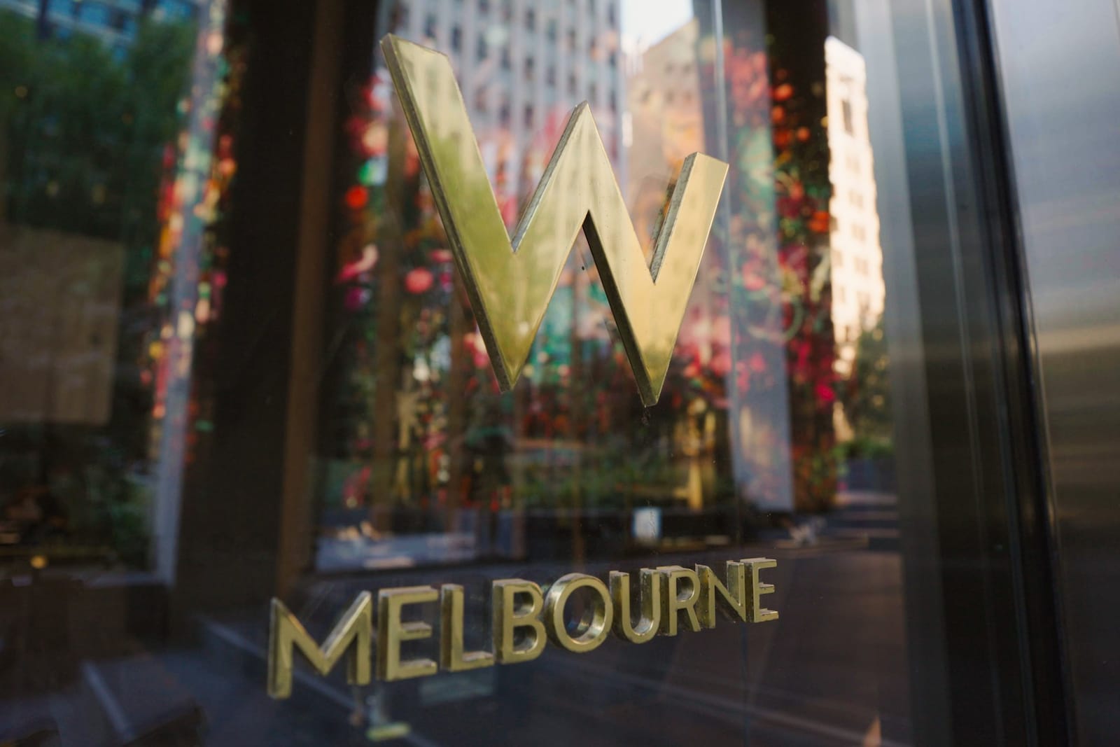Exterior image of W Melbourne logo reflected in a window.