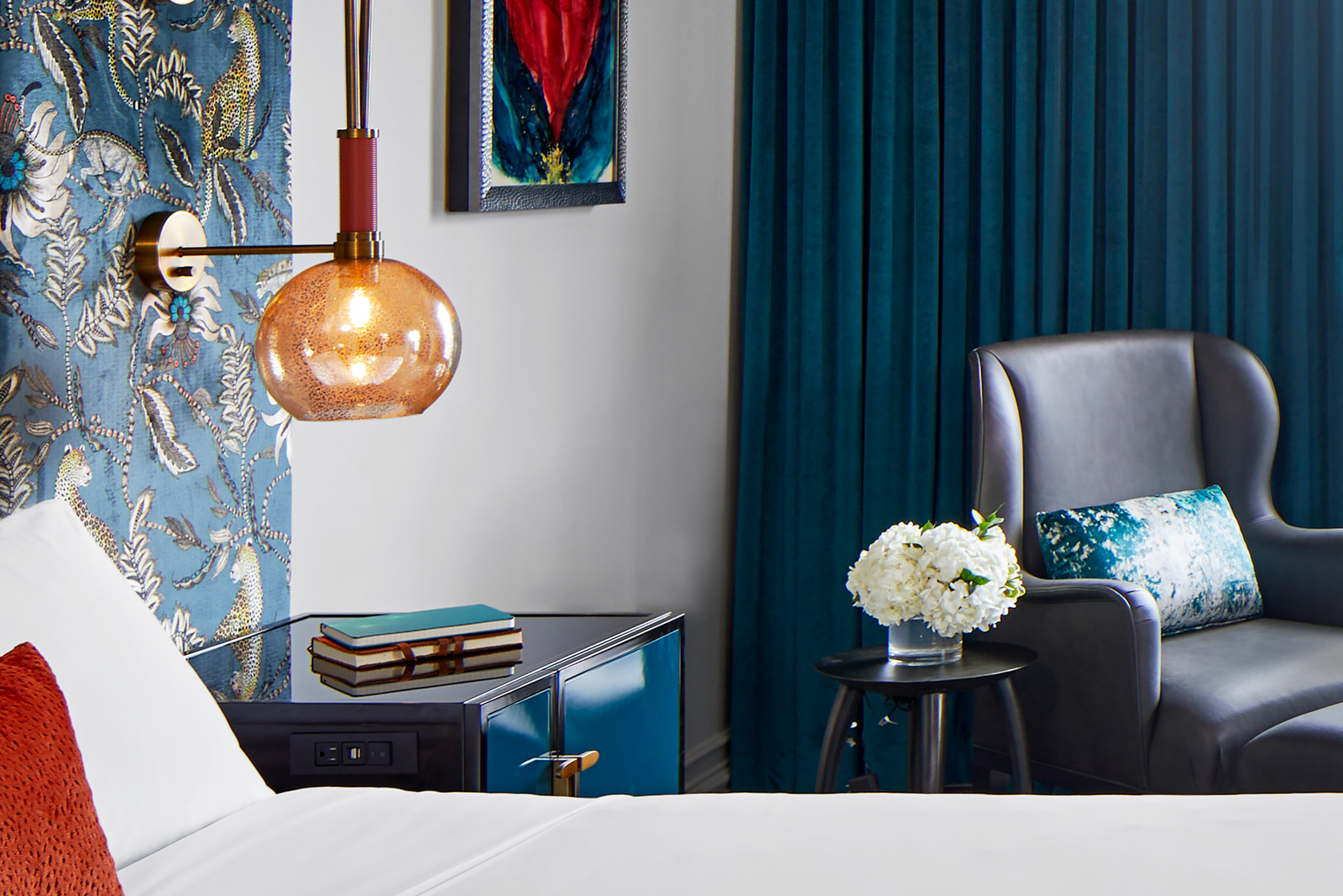Bed and nightstand with adjacent seating area.