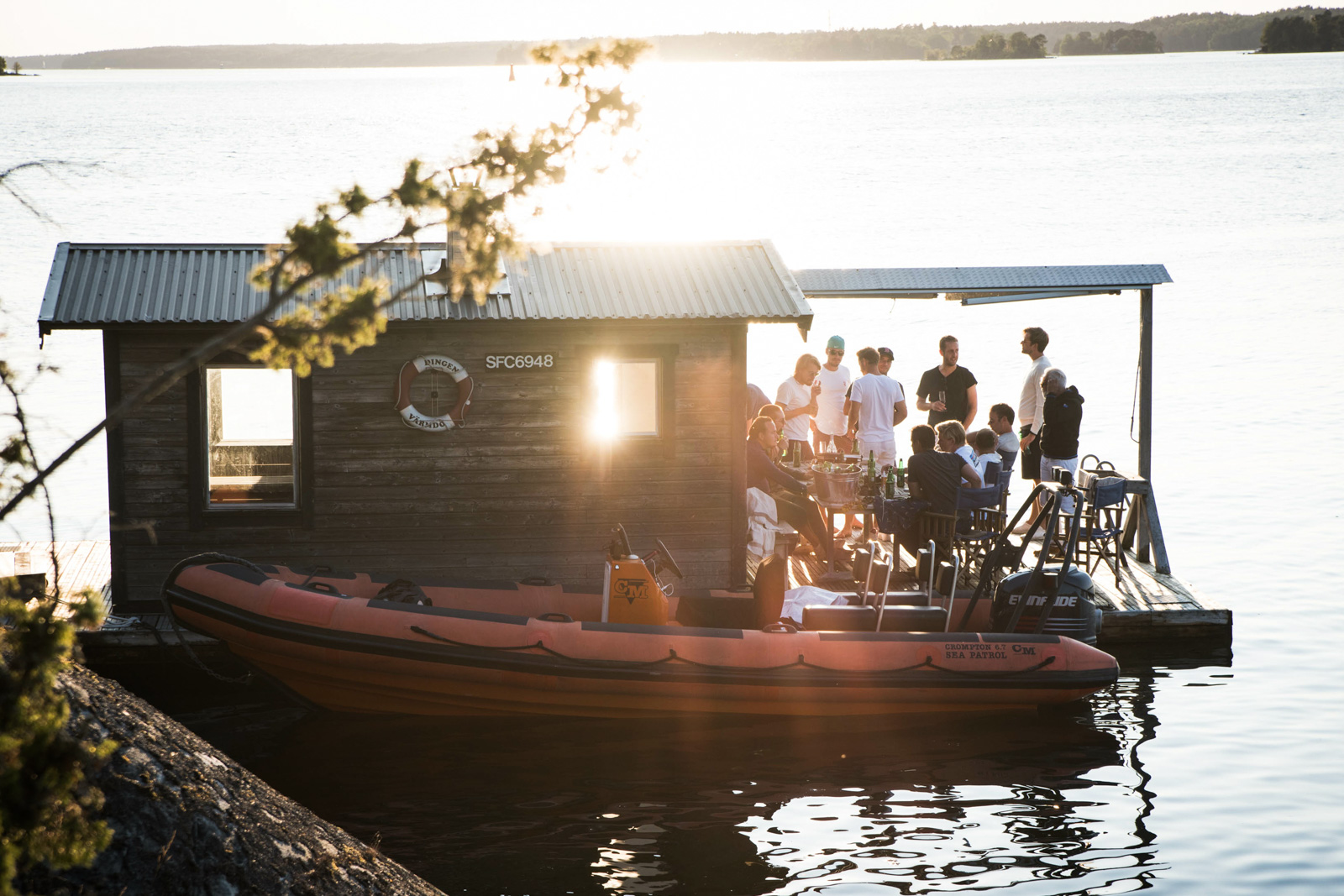People standing on a boat in an archipelago.
