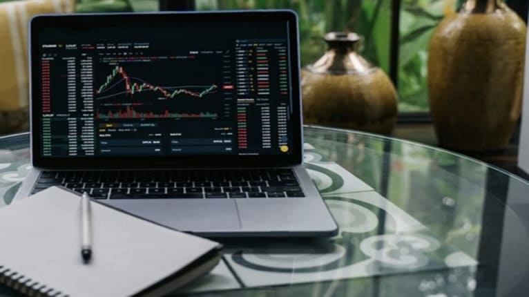 Person adjusting savings goal on laptop during oil price crisis and inflation