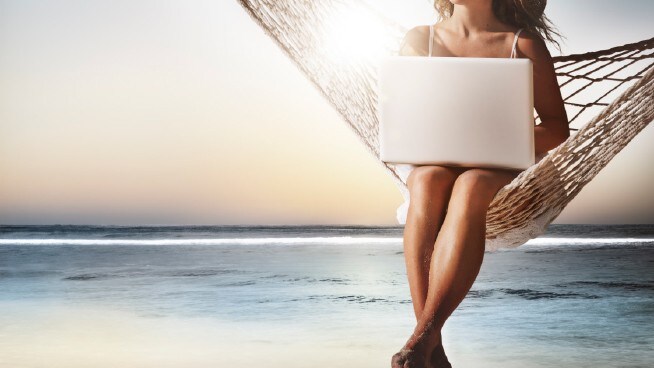 image women with computer on hammock