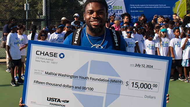 Group posing with a $15,000 check